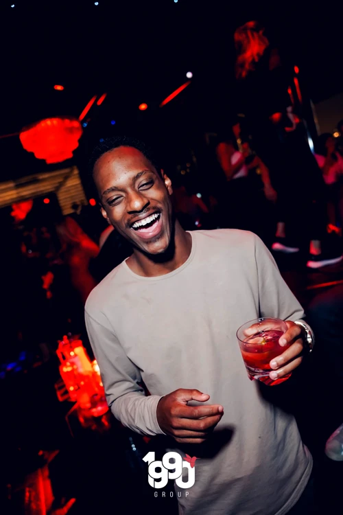 Guests celebrating with sparklers and drinks, capturing the lively atmosphere of Fuego Thursdays in Manhattan.